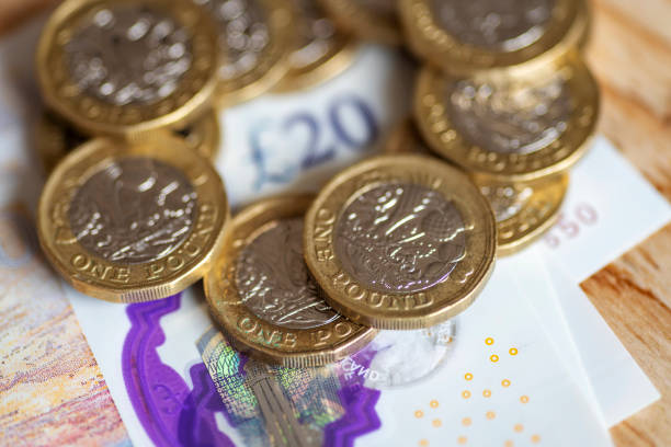 New Twenty pound note released 20 Feb 2020 surrounded by pound coins New Twenty pound note released 20 Feb 2020. Macro close up of this new polymer note with the £20 in the corner surrounded by pound coins. twenty pound note stock pictures, royalty-free photos & images