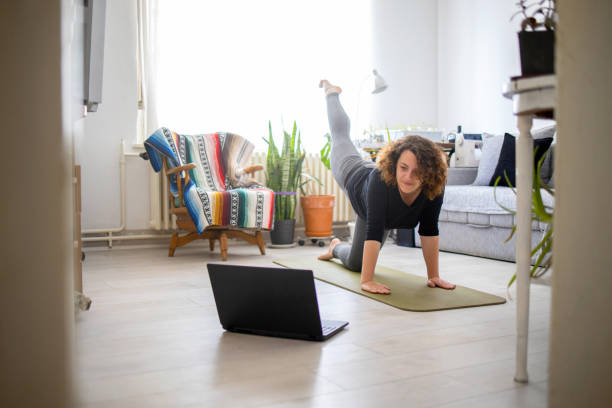 istock Young woman practicing yoga at home 1224170228