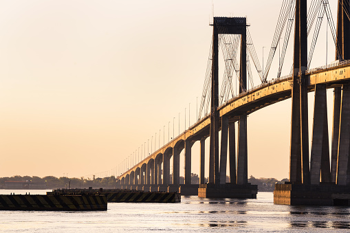 Corrientes Bridge seen from the coast during sunset on a sunny day - Corrientes, Argentina.