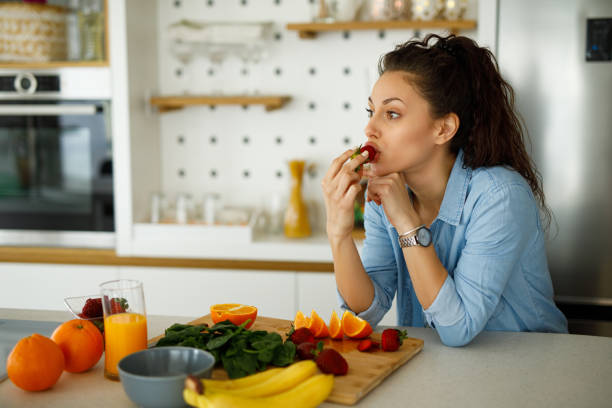 istock Young woman making a healthy snack with fruit at home 1224171317