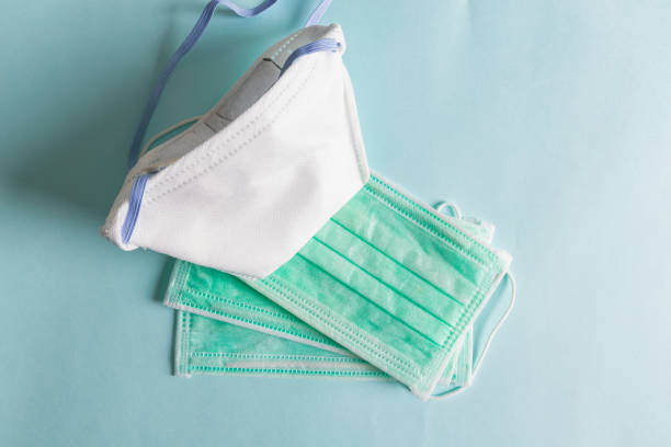 istock Surgical ear-loop green masks. Personal hygiene concept. Top view 1224174592