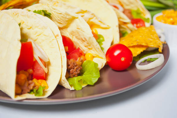 istock Mexican tacos with chicken meat, beans, tomatoes and corn 1224174643