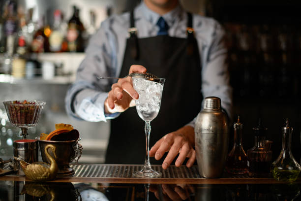 istock bartender holds transparent glass covered by sieve 1224177719