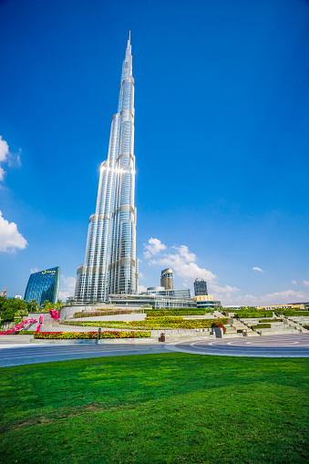 Dubai, UAE - December 6. 2019 - The green Burj Park in Dubai next to the Burj Khalifa with tour around the Dubai fountain
