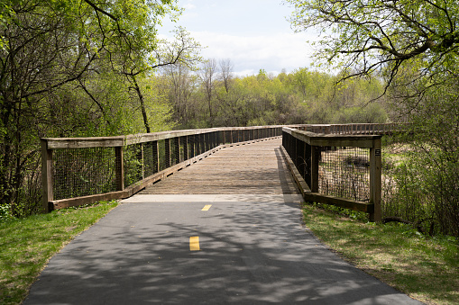 Pedestrian bridge over a creek and marsh wetland in Elm Creek Park Reserve - Maple Grove, Minnesota