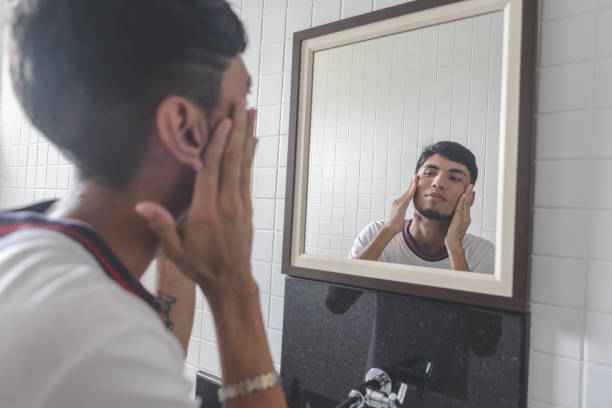 istock Young man looking at himself on the mirror in the bathroom 1224184852