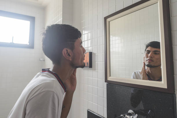 istock Young man looking at himself on the mirror in the bathroom 1224184853