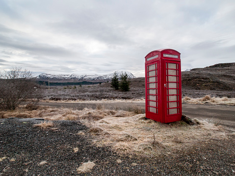 A red telephone kiosk on a frosty day in a remote location in the Highlands, Scotland