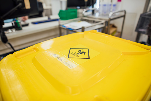 A shot of a yellow clinical waste container in a Science Laboratory.