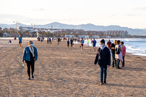 Valencia, Spain 10th May 2020 People walking and playing sports in the Malvarrosa Beach during the coronavirus pandemic in the time slot allocated by the Government. Walking and individual sport activities are allowed with some limitations and respecting social distancing measures