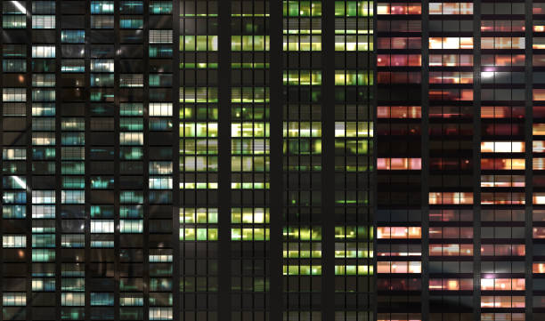 skycraper windows facade by night stock photo