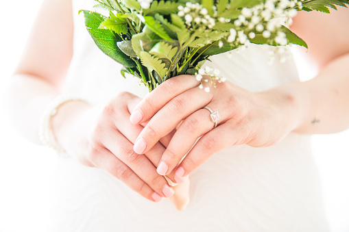 Bride with White Gold Wedding Ring Holding Fresh Gypsophila Bouquet