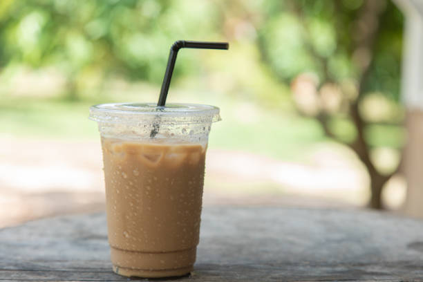 istock Iced coffee on cup on wooden  nature background 1224192584