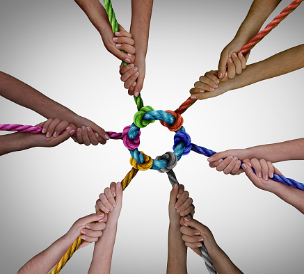 Diverse employees team meeting as a business concept for pulling together for work teamwork success and diversity symbol as a unified group working in unity.