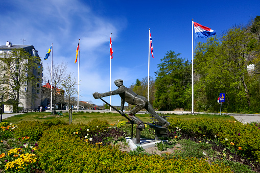 Soderkoping, Sweden May 10, 2020 S statue of a man opnening a lock in the Slussen or lock area on the coast to coast Gota Canal.