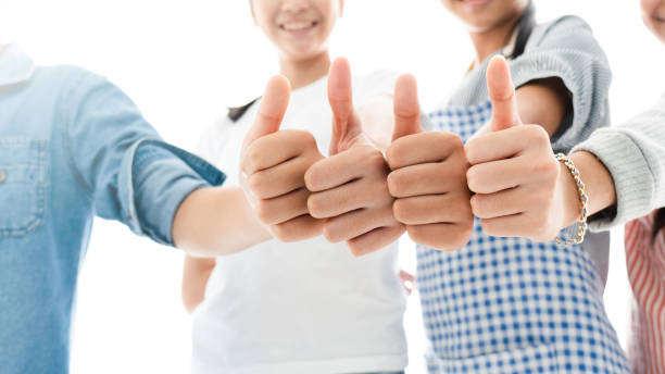Close up portrait group of people giving thumbs up. Congratulate Or satisfied that the work was successful. Cooperation in living together in society. Unity of people. Concept New Normal stock photo