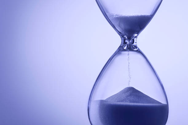 istock Blue toned hourglass with running sand 1224198541