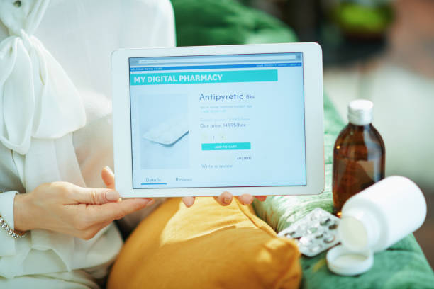 istock modern female showing online pharmacy store on tablet PC 1224201420