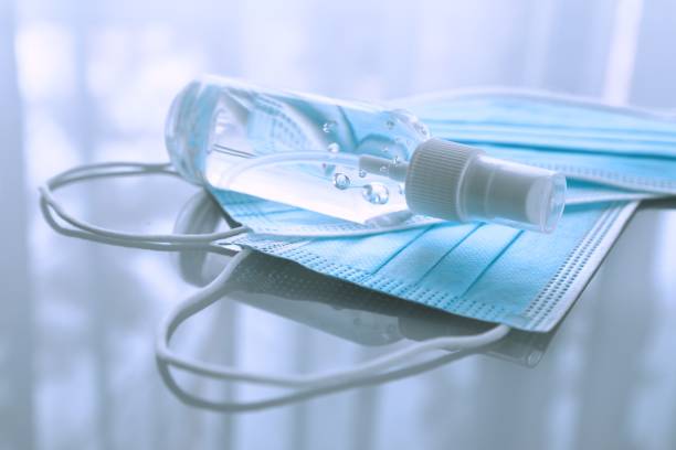 istock Disposable medical masks and hand sanitizer 1224201543