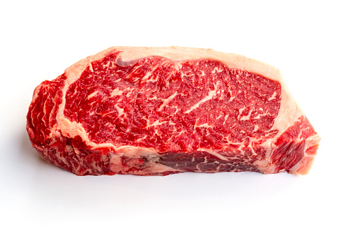 Raw Prime boneless beef loin New York strip steak isolated on white background.