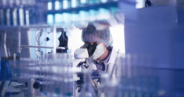 istock Shocked female microbiologist studying coronavirus - protective workwear 1224202372
