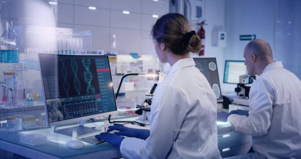 istock Multi ethnic research team studying DNA mutations. Female doctor in foreground 1224202586