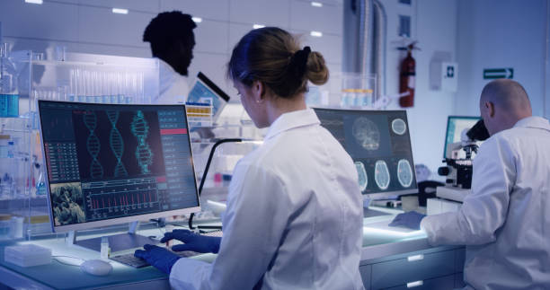 istock Multi ethnic research team studying DNA mutations. Female doctor in foreground 1224202649