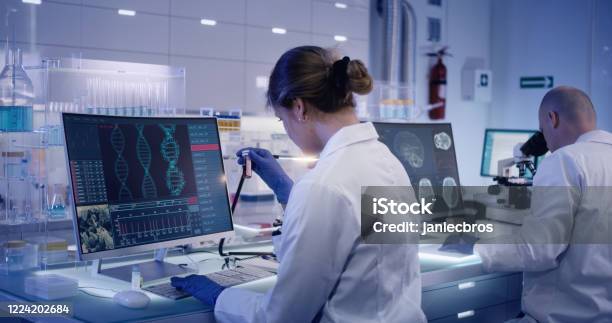 Multi Ethnic Research Team Studying Dna Mutations Female Doctor In Foreground Stock Photo - Download Image Now