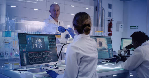 istock Multi ethnic research team studying DNA mutations. Female doctor in foreground 1224202708