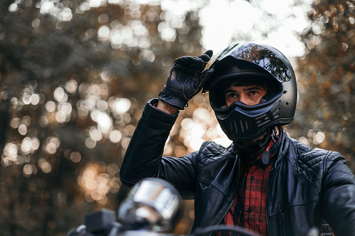 leather gloves and a motorcycle helmet on a dark background. The concept of motorcycle equipment.