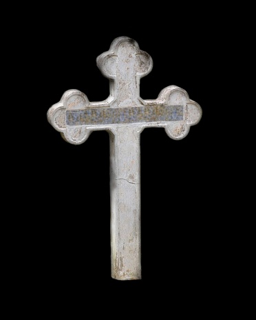 A wooden christian cross on a black background from a shrine site near Quito, Ecuador