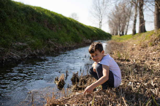istock A cute boy playing at the creek 1224205673