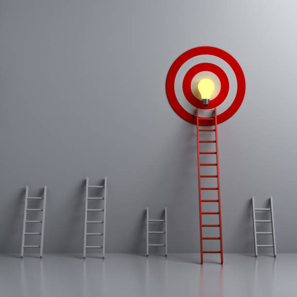 istock Stand out from the crowd and different creative idea concepts Longest red ladder aiming high to goal target with bright idea bulb among other short ladders on dark white background 1224206055