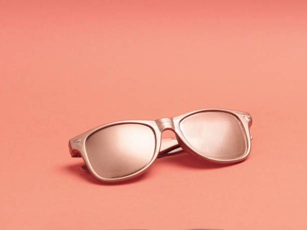 istock Golden sun glasses on a pink background. 1224206631