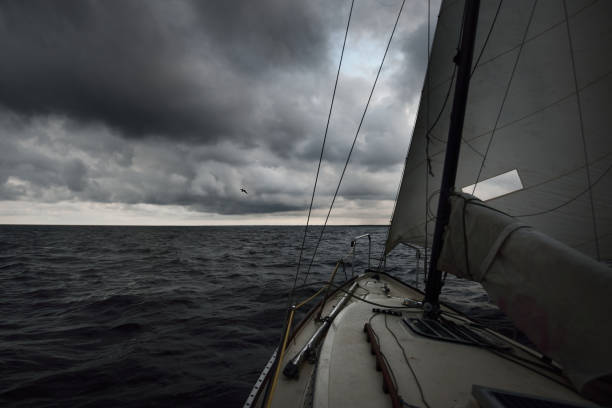 istock Modern small 24 feet racing sloop rigged yacht sailing in a thunderstorm. Terrific cloudscape. Dark storm sky. Baltic sea, Latvia 1224206813
