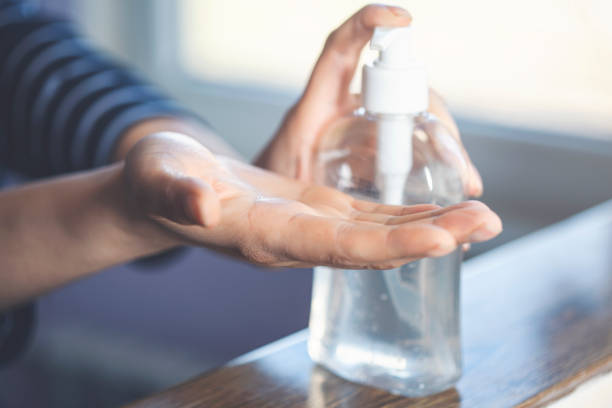 istock Woman putting hand sanitizer in her hand 1224207434