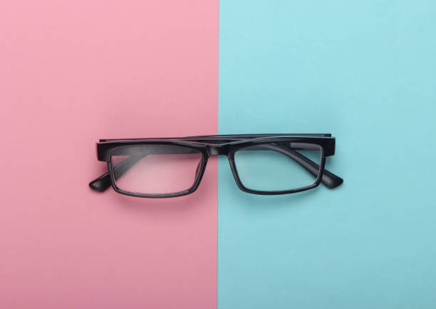 istock Classic eyeglasses on pink blue pastel background. Top view. Minimalism 1224208041
