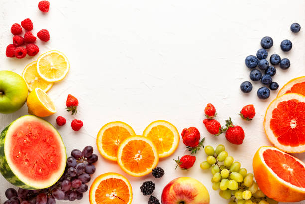 Assorted fresh fruits and berries on white background.
