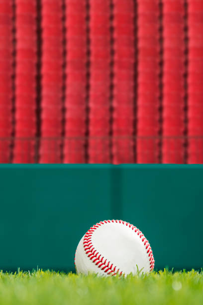 istock A Baseball in the grass with red empty seats in the background 1224208122