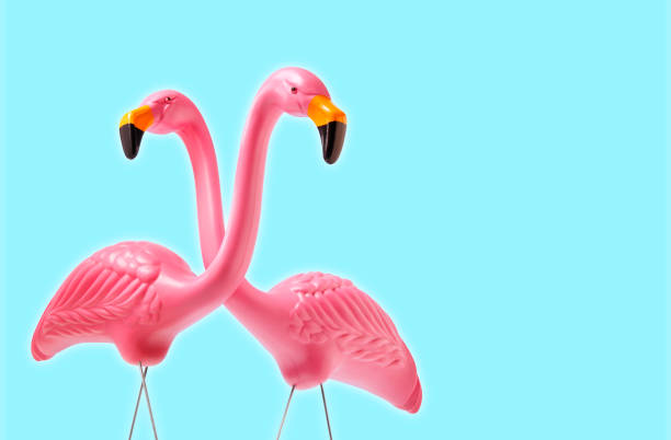 istock Decorative Pink Flamingos Against Blue Background 1224208169