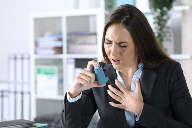 istock Executive holding inhaler with asthma attack at office 1224208297