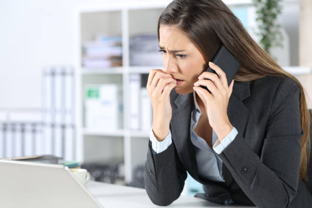 istock Nervous executive calling on phone looking laptop at office 1224208692