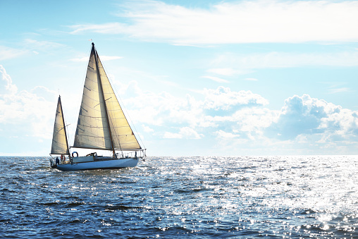 Sail, closeup and a boat on the water for travel, luxury cruise or adventure during summer. Sailing, ship and a yacht on the ocean for a holiday, vacation or to explore nature at sea