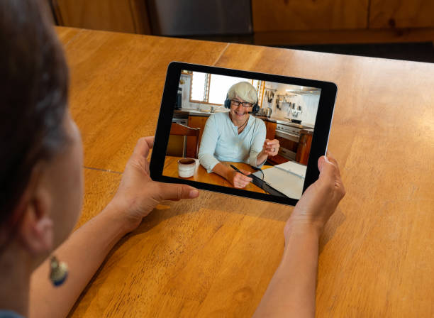 istock COVID-19 Working from home. Manager in tablet screen working remotely with team colleague in video conference. Online meeting with coworker in Coronavirus lockdown and social distancing. 1224210131