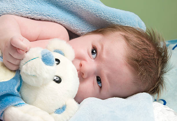 istock newborn baby with bear 122421060