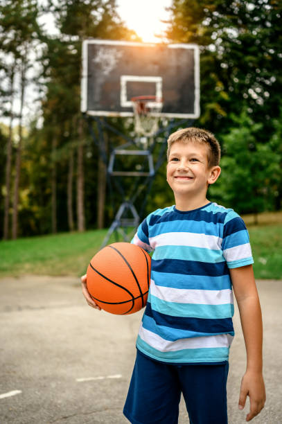 istock Young boy playing basketball 1224210780