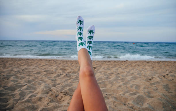 Woman on beach with marijuana socks