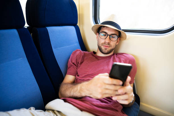 istock Playing games on the phone to pass time on a train 1224211654