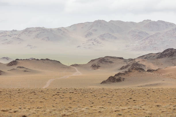 istock Mongolia landscape. Winding dirt road through lush rolling hills of Central Mongolian steppe. Mongolian Altai 1224212437