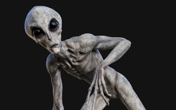 a gray alien on dark background with clipping path. stock photo